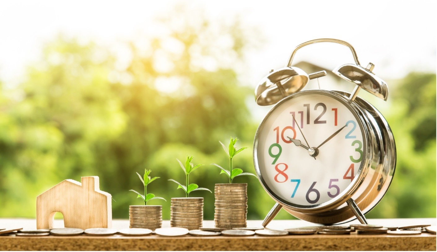 A tiny model of a house, some change, and a clock