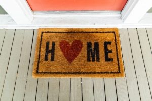 A 'home' mat in front of the door.