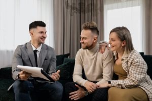 A couple talking to a real estate agent.