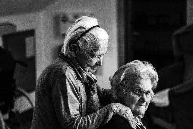 Two senior women being friendly