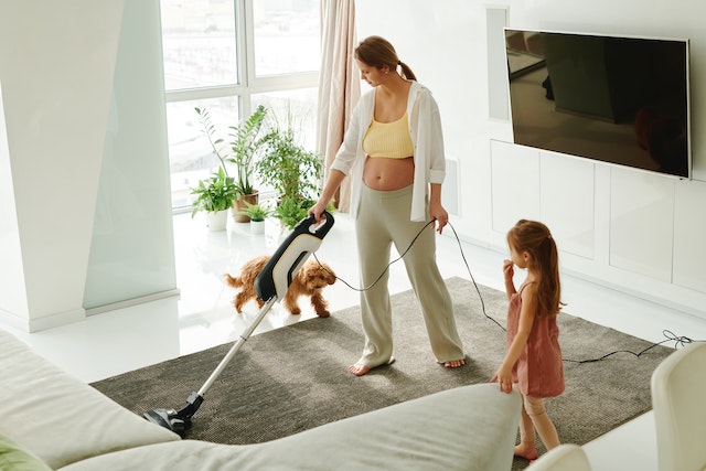 a woman vacuuming for staging her home