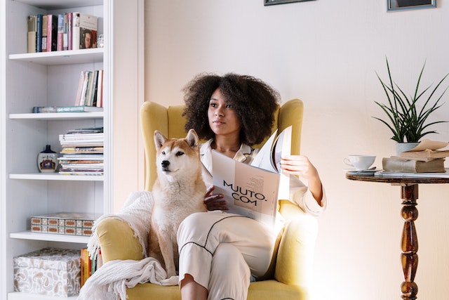 a woman reading home staging tips for pet owners with her dog