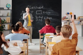 A teacher is speaking to the class.