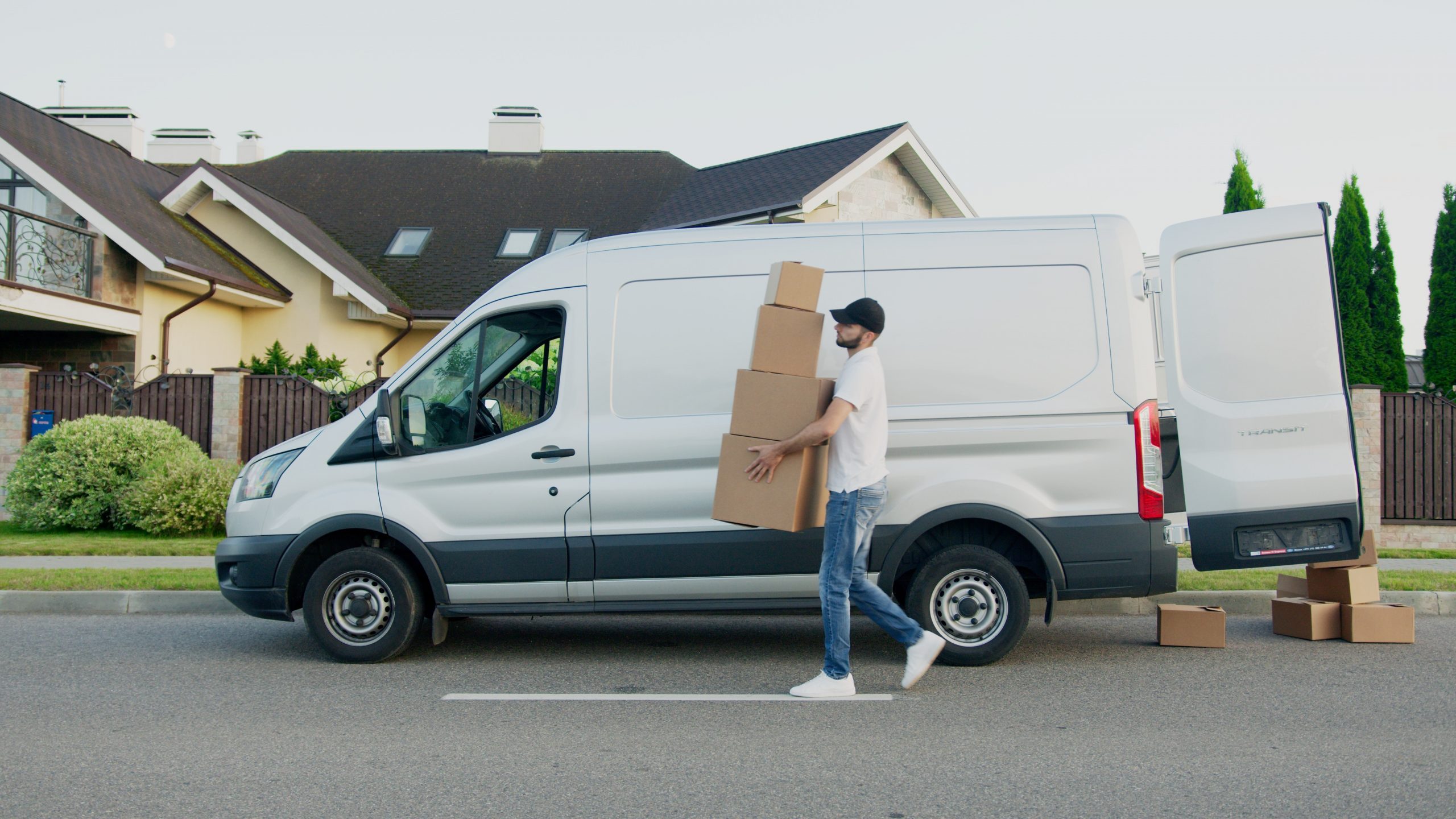A professional mover moving boxes out of his van.