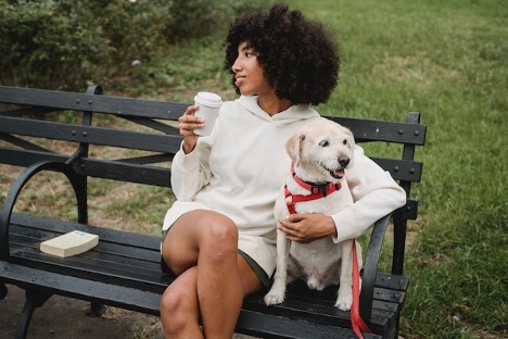 woman with a dog on a bench in one of the best places in California for dog owners
