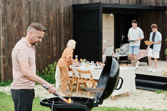 Family having a barbeque in their backyard.