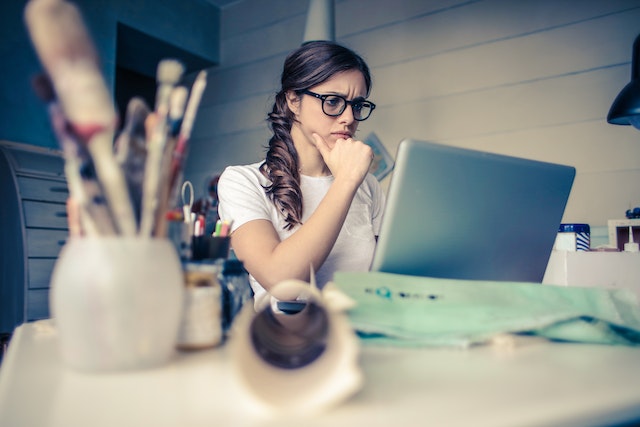 Woman looking at a laptop in an office