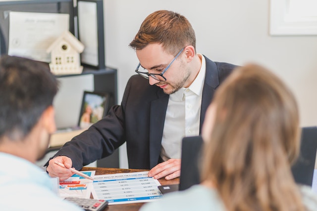 Realtor showing something to his clients