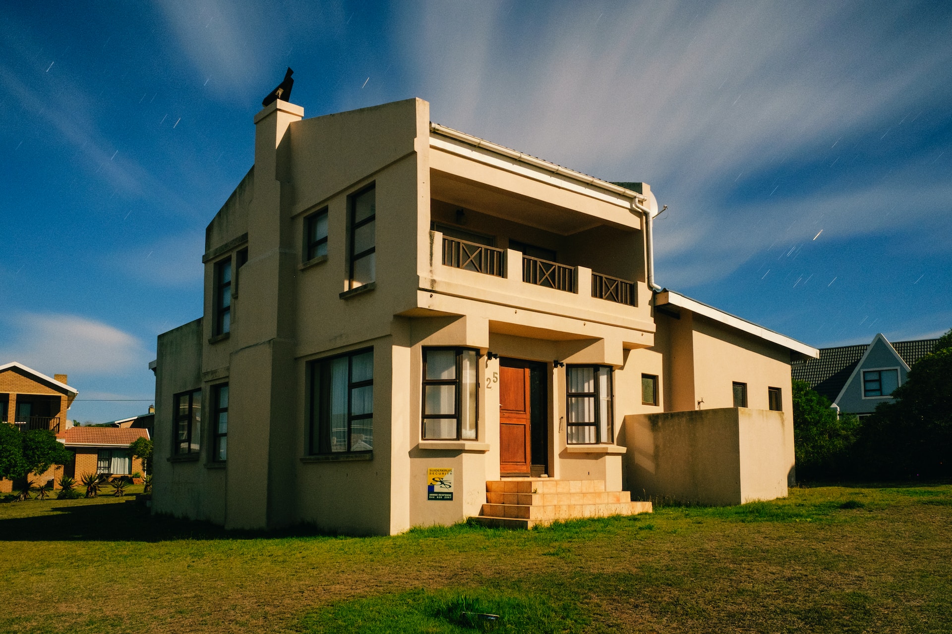 A beige house in a good neighborhood with only the positive hidden factors that influence home values