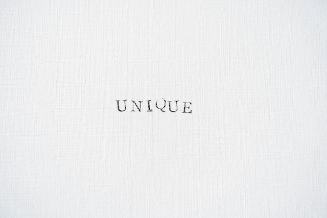 The word UNIQUE on a gray wall