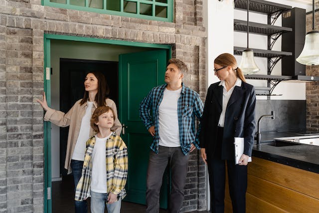 A family during an open house with a realtor.